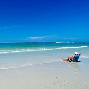 photo gallery woman in beach chair at Siesta Beach